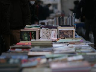 a table full of books on a city street